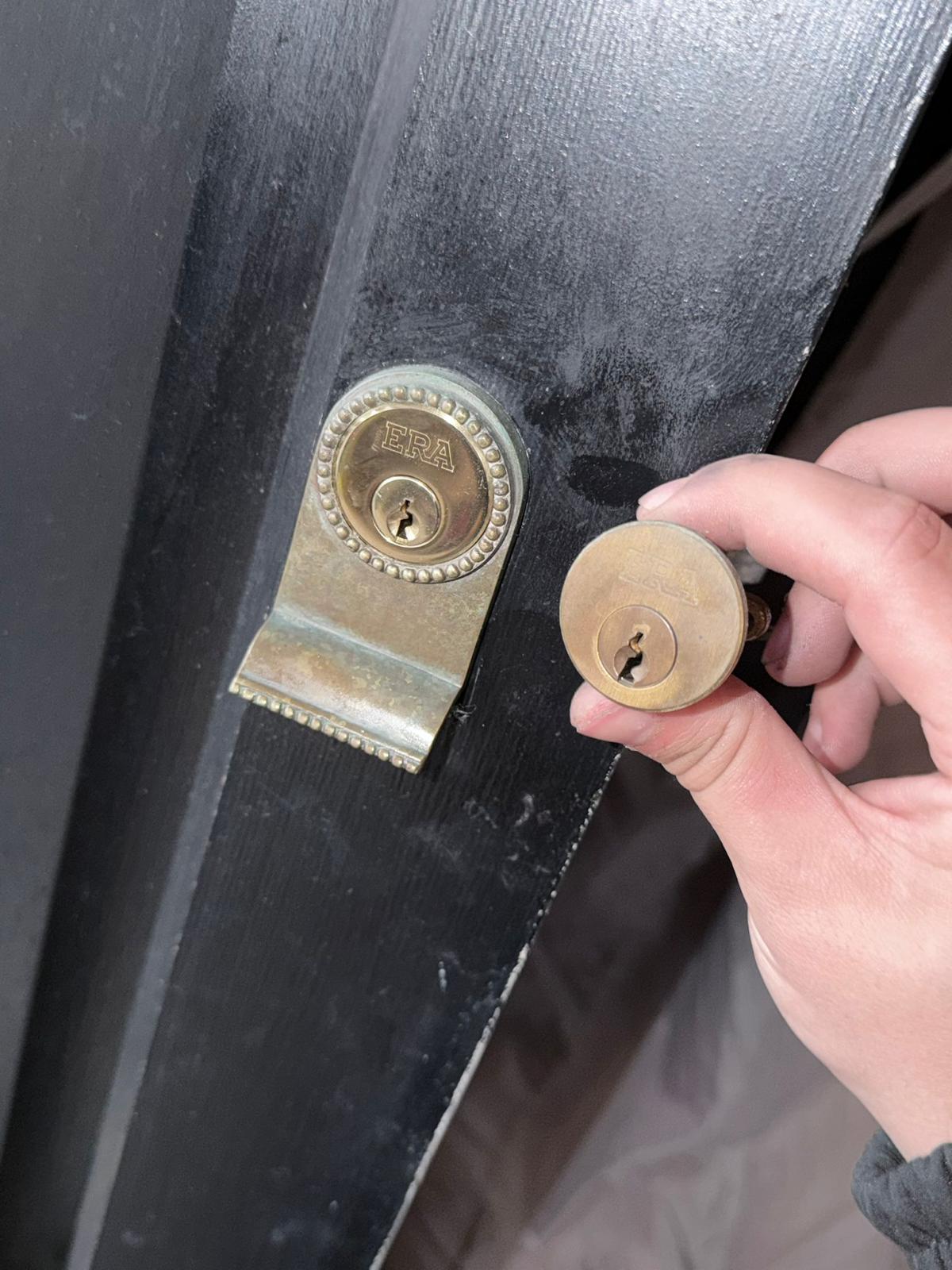 ERA euro cylinder held next to a fitted door lock